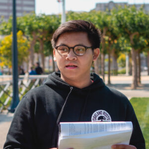 An AAMPLIFY student taking notes during a workshop at Civic Center Plaza, San Francisco.
